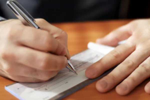A person writing a check.