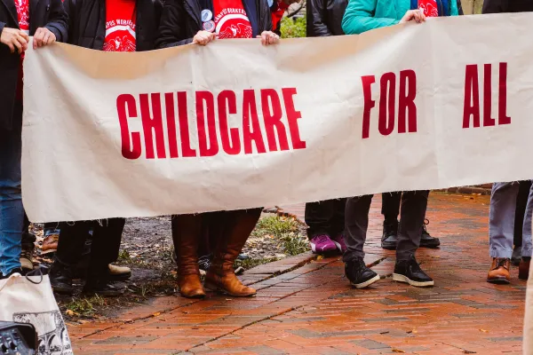 United Campus Workers of Virginia members holding a banner that reads "Childcare for All" at the 2023 Lobby Day rally in Richmond.