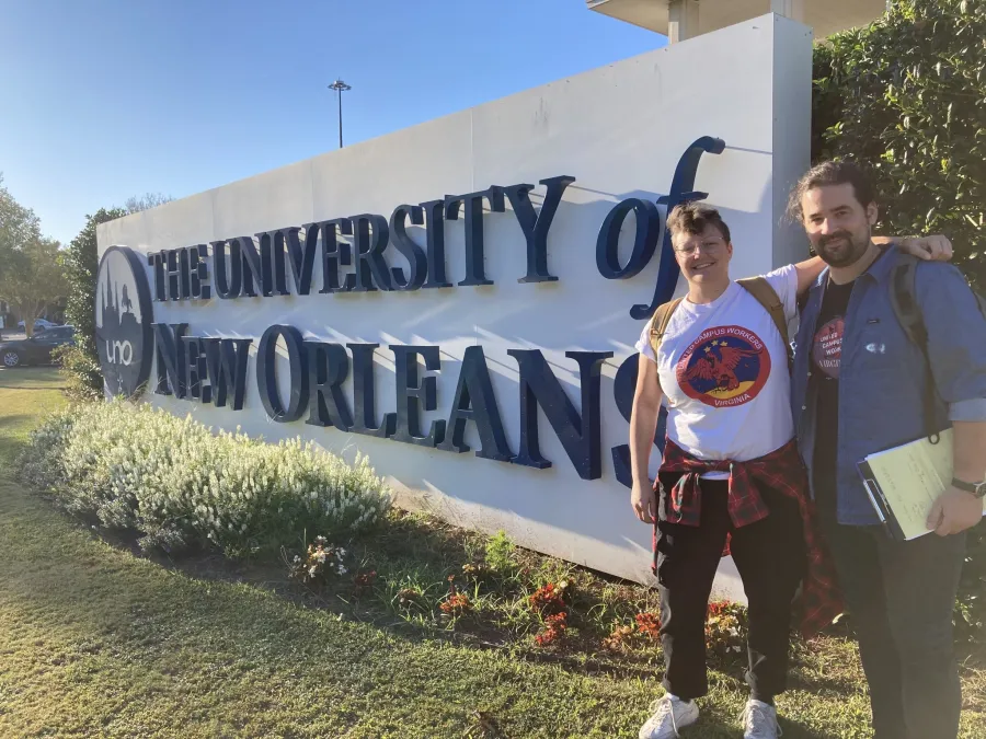 UVA Chapter Chair Laura Ornee and William & Mary Chapter Chair Nathan Romans posing in front of the University of New Orleans sign during the organizing blitz