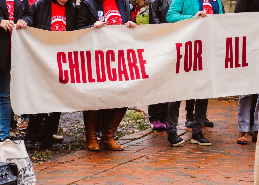 United Campus Workers of Virginia members holding a banner that reads "Childcare for All" at the 2023 Lobby Day rally in Richmond.